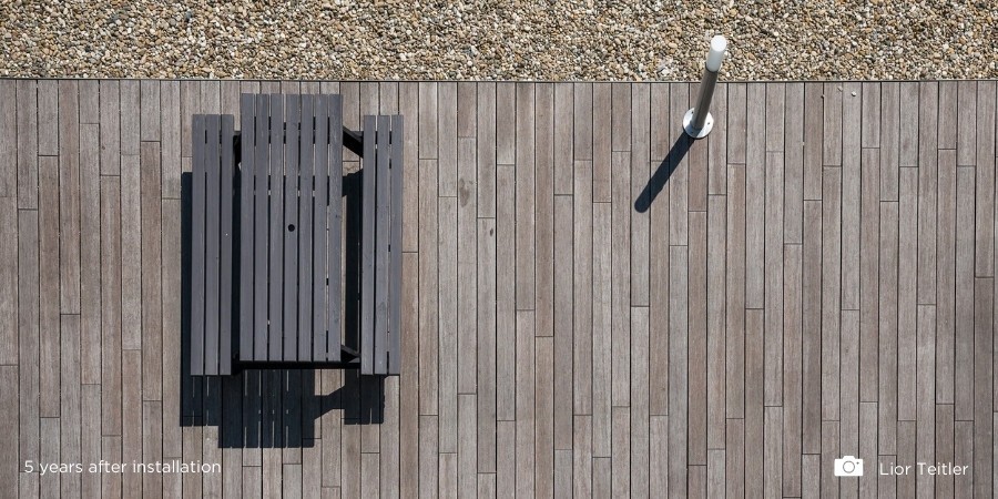 How do bamboo decking and cladding boards change colour?